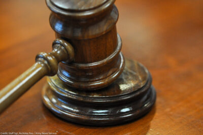 Photo of gavel on judge's bench.