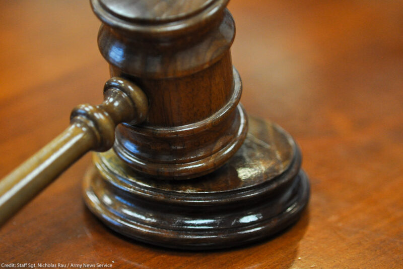 Photo of gavel on judge's bench.