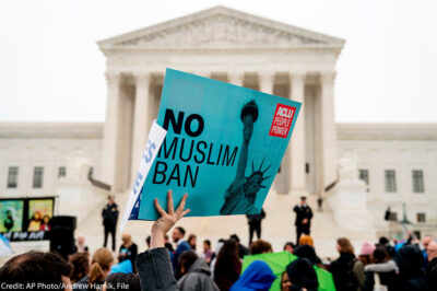 In this April 25, 2018 file photo, a person holds up a sign that reads "No Muslim Ban" during an anti-Muslim ban rally in front of the Supreme Court building in Washington, DC.