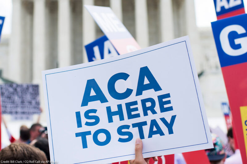 Affordable Care Act Supporter waves sign that reads 