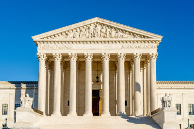 Photo of the front of the Supreme Court building on a sunny day