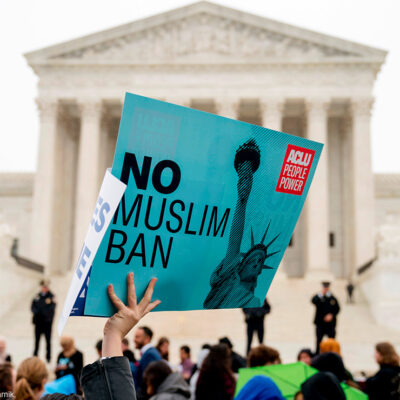 A person holds up a sign that reads "No Muslim Ban" during an anti-Muslim ban rally at the Supreme Court.