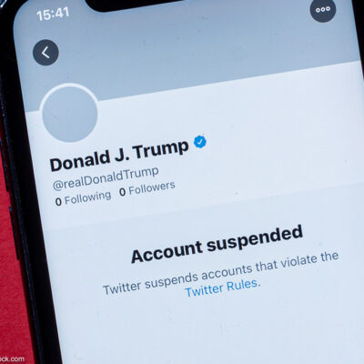 A smartphone showing Donald J. Trump's suspended Twitter account.