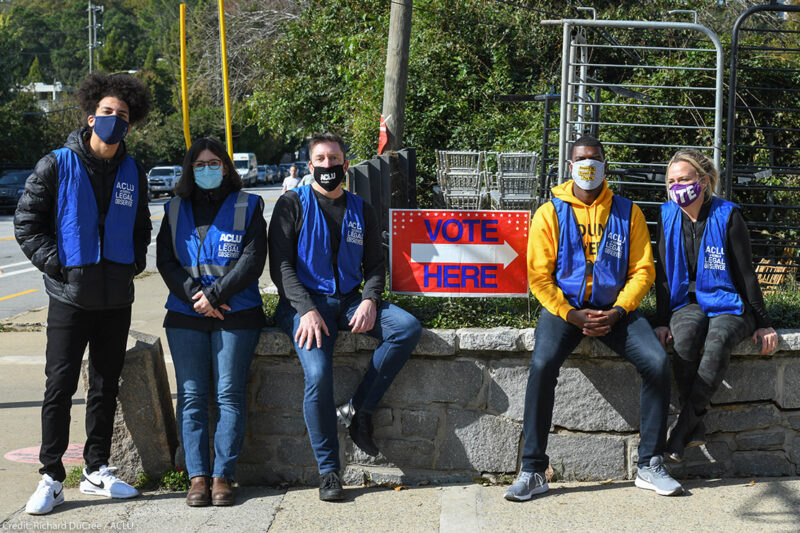 ϰſ legal observers sit by a "Vote Here" sign outside a polling place in Georgia on Election Day.