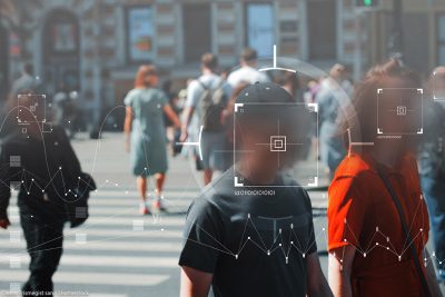 Face recognition and personal identification technologies in street surveillance cameras covering people's faces.