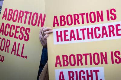 Protest signs advocating for abortion access.