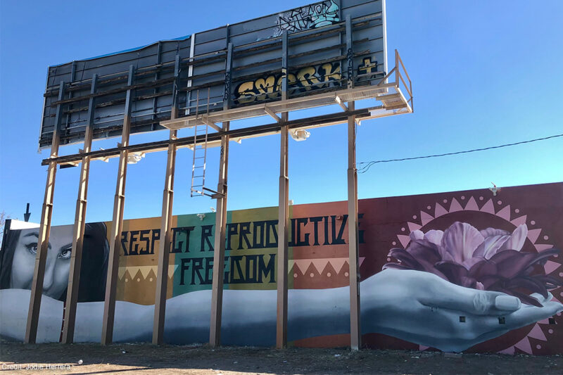 A mural with the text "Respect Reproductive Freedom."