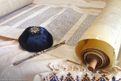 The Hebrew handwritten Torah, on a synagogue alter, with Kippah and Talith