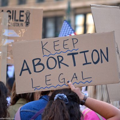 People protesting in support of abortion rights, holding sign that reads "Keep Abortion Legal"