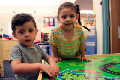 A young boy and girl play with their toy cars to wrap up the day at a day care Albuquerque, New Mexico