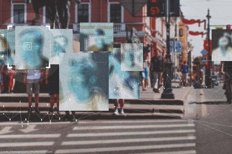 Face recognition boxes placed over people's faces as they cross the street