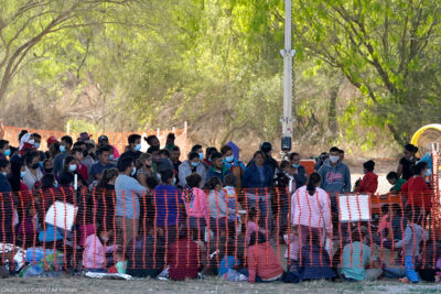 Migrants in custody at U.S. Customs and Border Protection processing area under the Anzalduas International Bridge, Friday, March 19, 2021, in Mission, Texas.