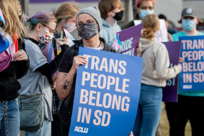 Protestor holds sign reading “Trans People Belong In SD” during trans rights rally.