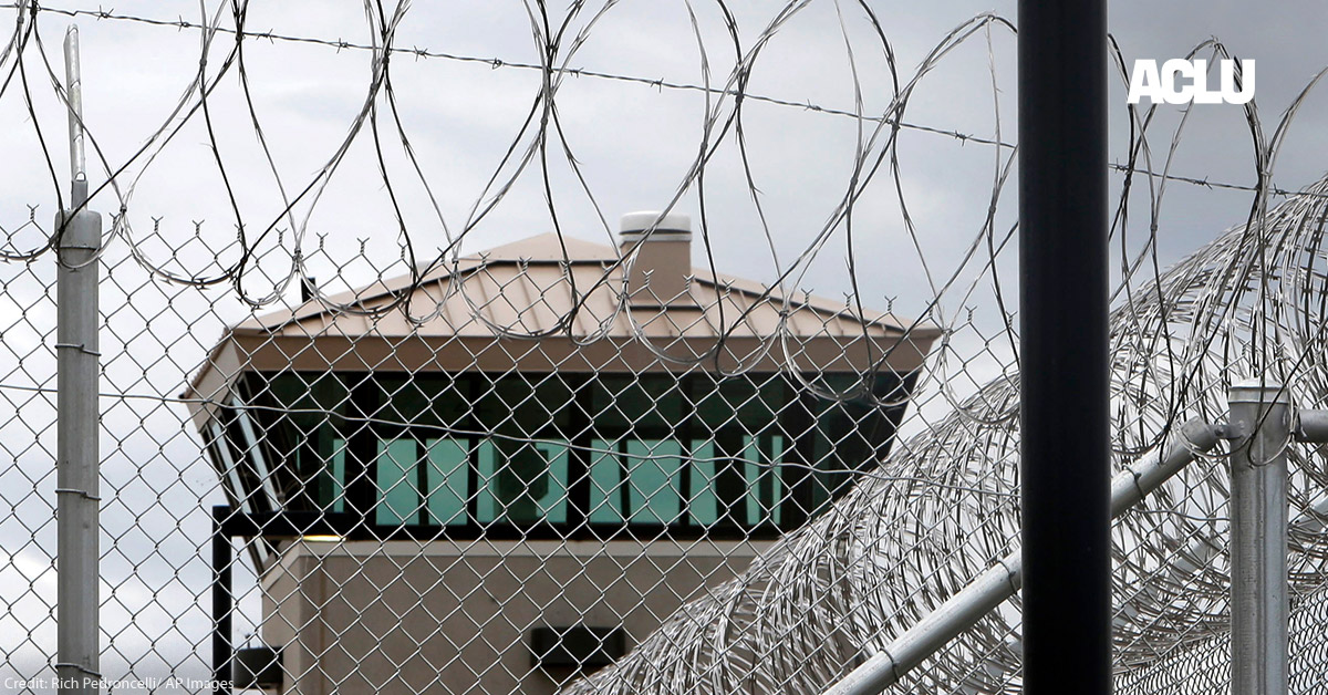 A guard tower over the fence at a correctional health care facility.