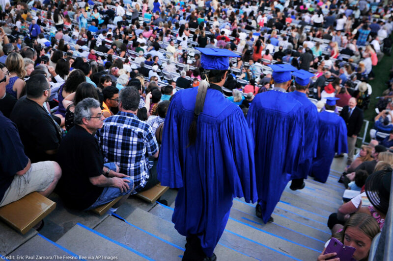 A Native American student is wearing an eagle feather to his high school graduation.