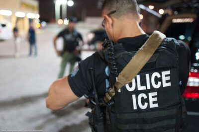 The back of a police vest reads "Police ICE"