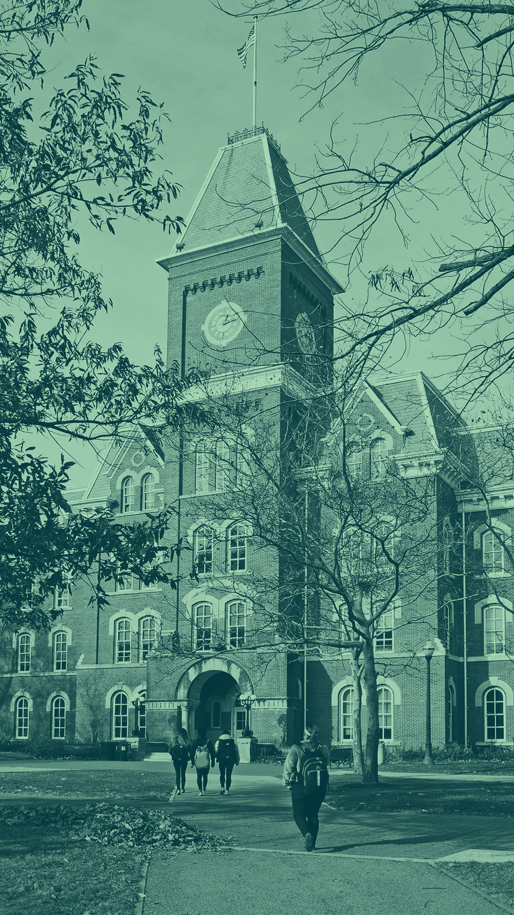 Green tinted picture of students walking on a college campus.