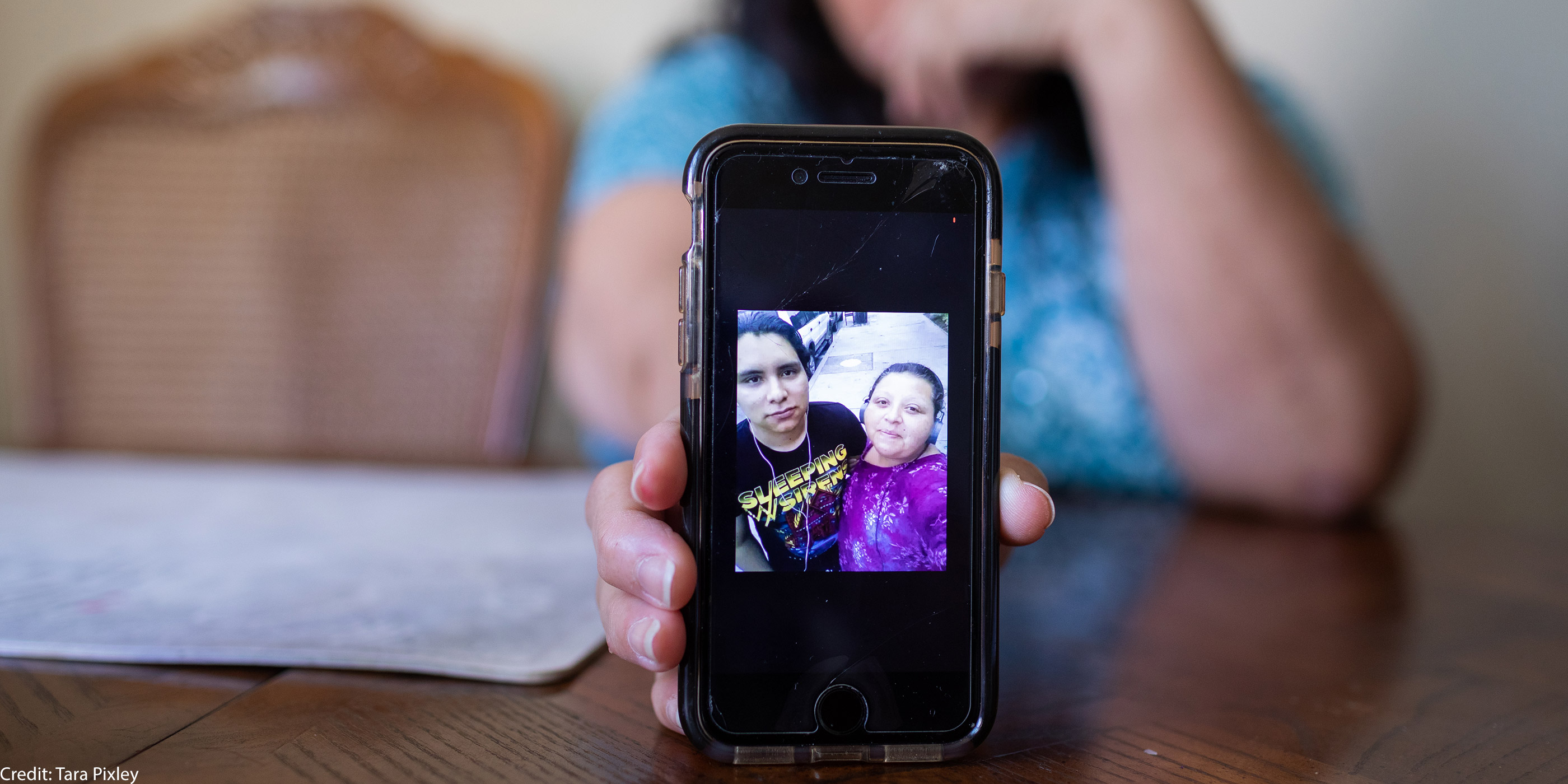 Celia Banos holding a photo of Jhean.