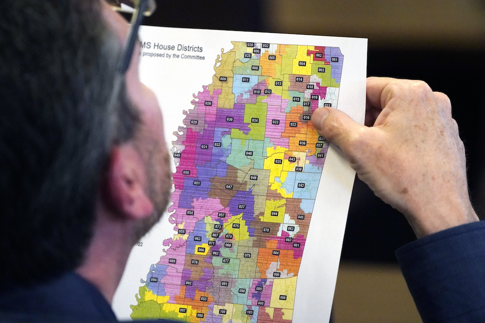 Rep. Dan Eubanks, R-Walls, examines a copy of the House redistricting map during a meeting of the House Legislative Reapportionment Committee.