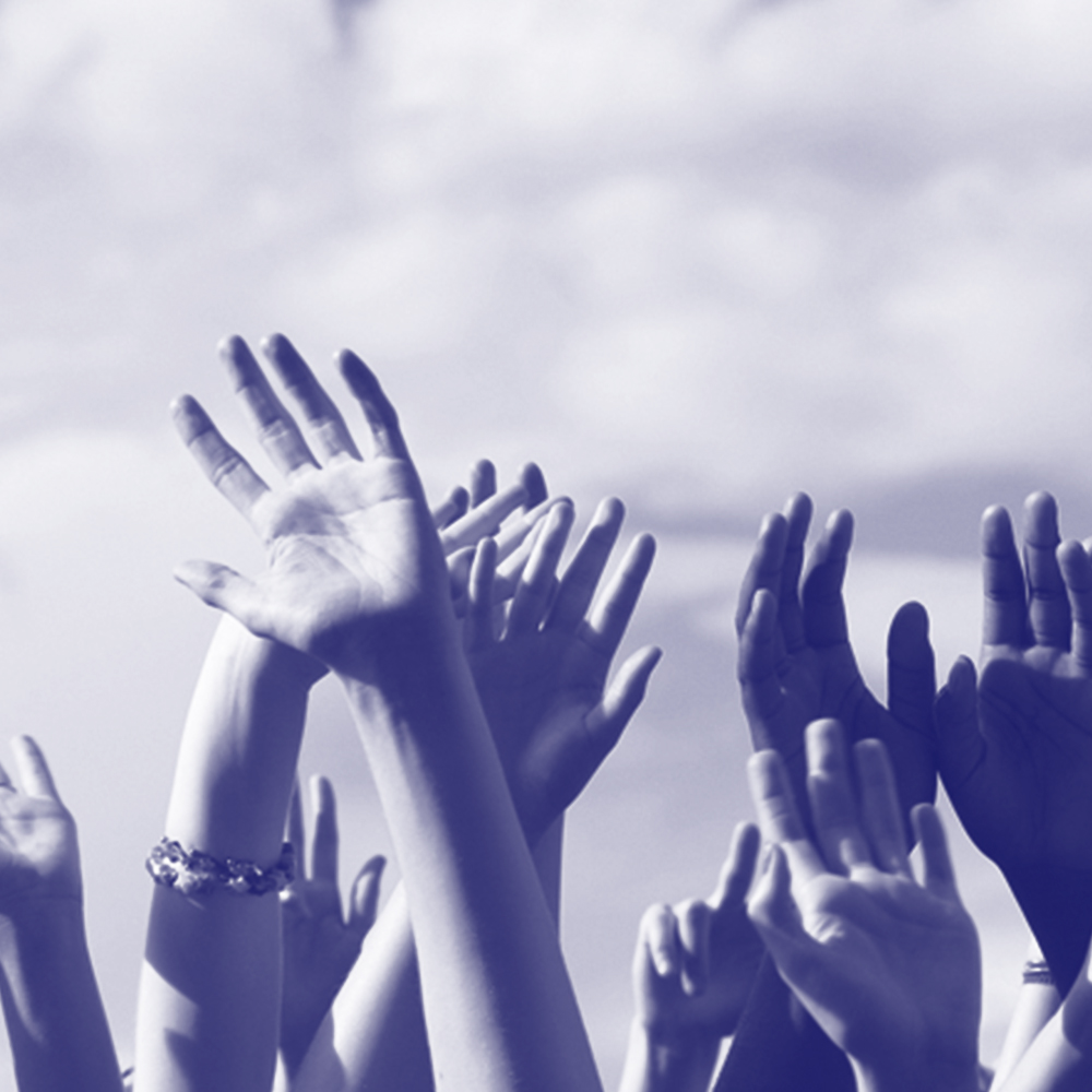 blue photo of a group of raised hands