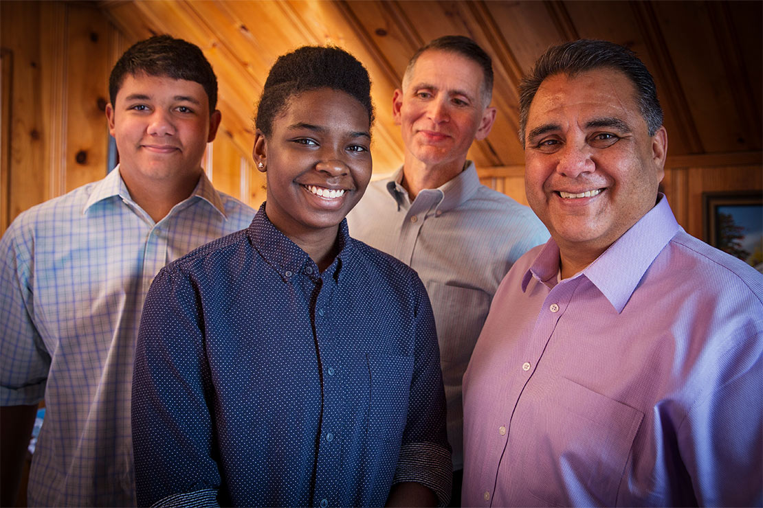 Greg Bourke and Michael DeLeon with their two children.