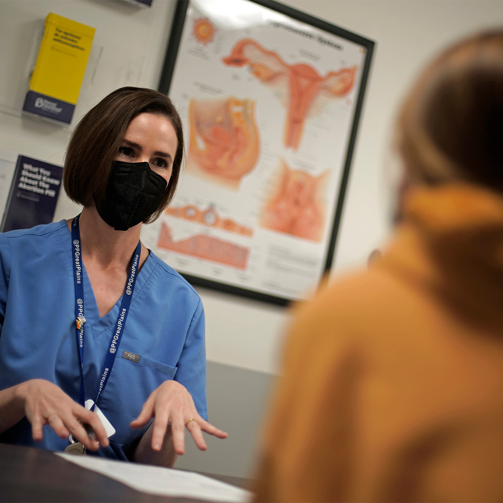 A doctor talks with a patient about the medical abortion process at a clinic in Kansas City, Kan.