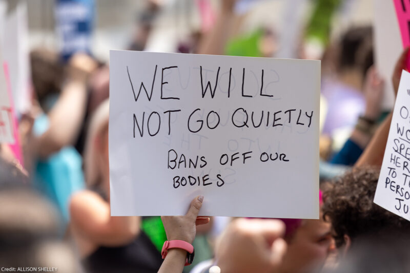 Abortion Rights protestor holds a sign reading "WE WILL NOT GOT QUIETLY, BANS OFF OUR BODIES"