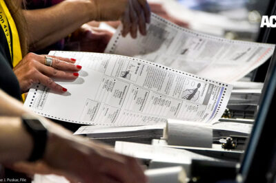 Election workers handle ballots at the Allegheny County Election Division warehouse in Pittsburgh.