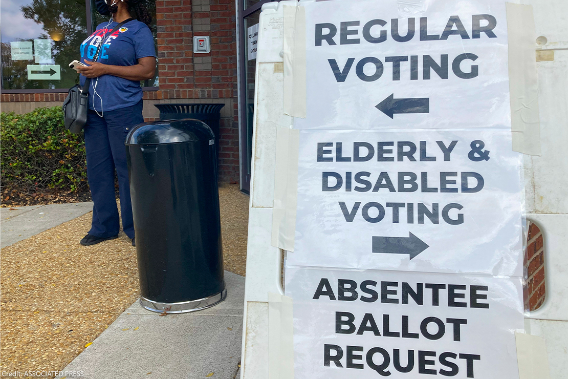 A sandwich board with directions posted on signs showing the way to vote outside a Cobb County voting building in Marietta, Ga.