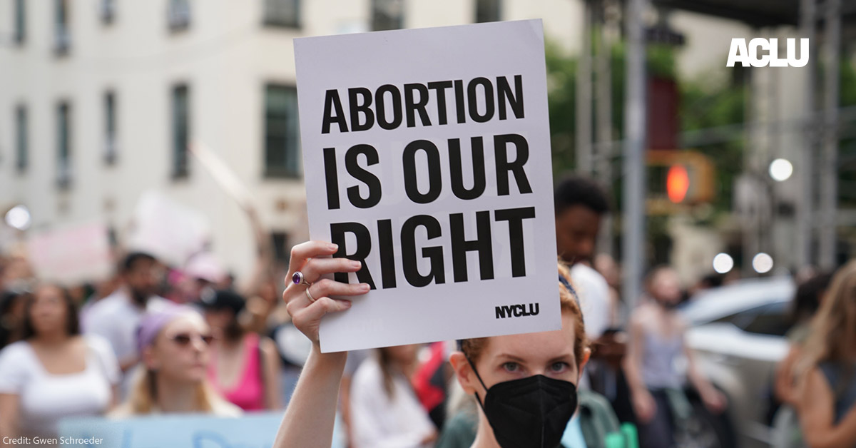 A demonstrator holding a sign that says Abortion is Our Right.