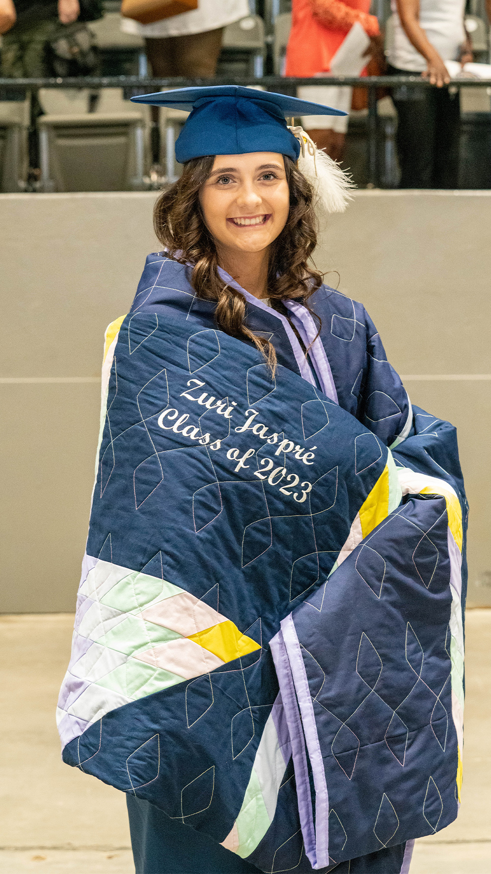 Wrapped in her tribal star quilt, Zuri Wilson beams.