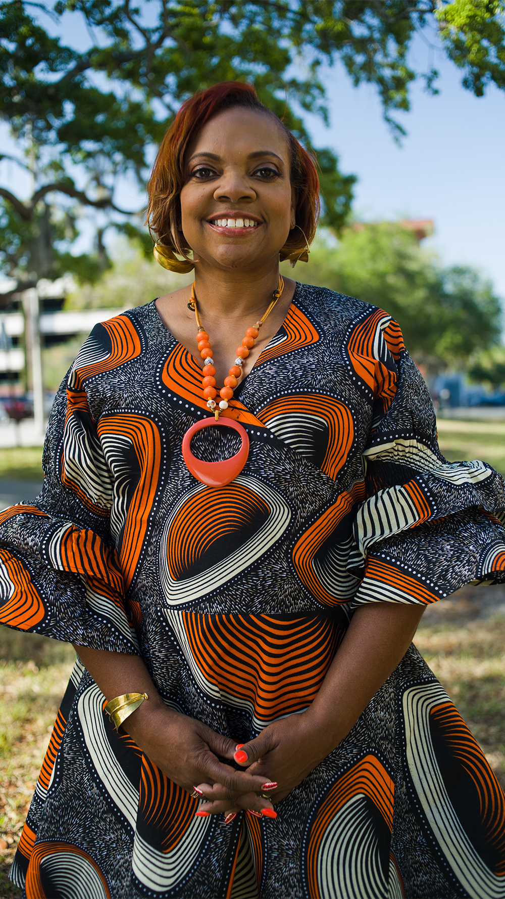 A smiling Dr. Dana Thompson Dorsey standing outside.