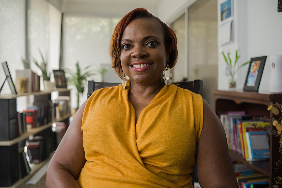 A smiling Dr. Dana Thompson Dorsey sitting in her office..