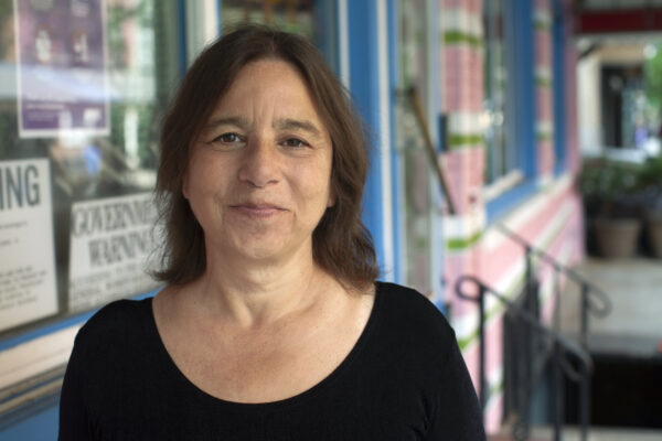 Headshot of writer Sarah Schulman smiling closed-mouth.