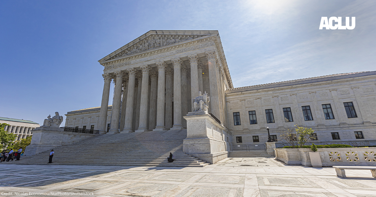 The U.S. Supreme Court building on a sunny day with a blue sky.