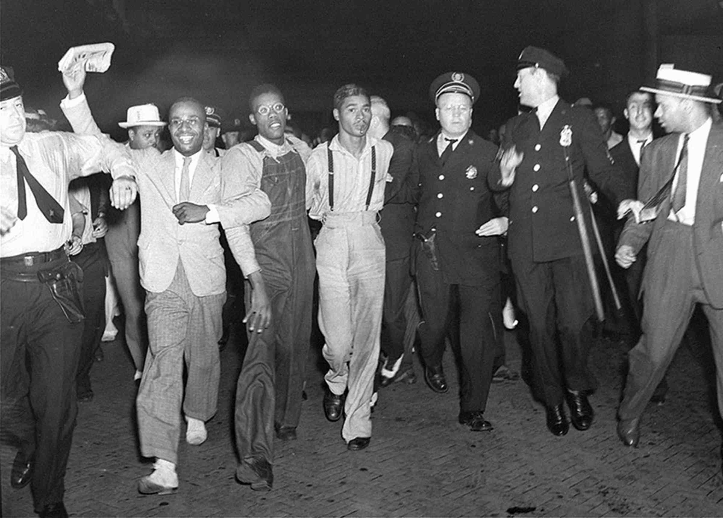 A black and white photo of seven men walking