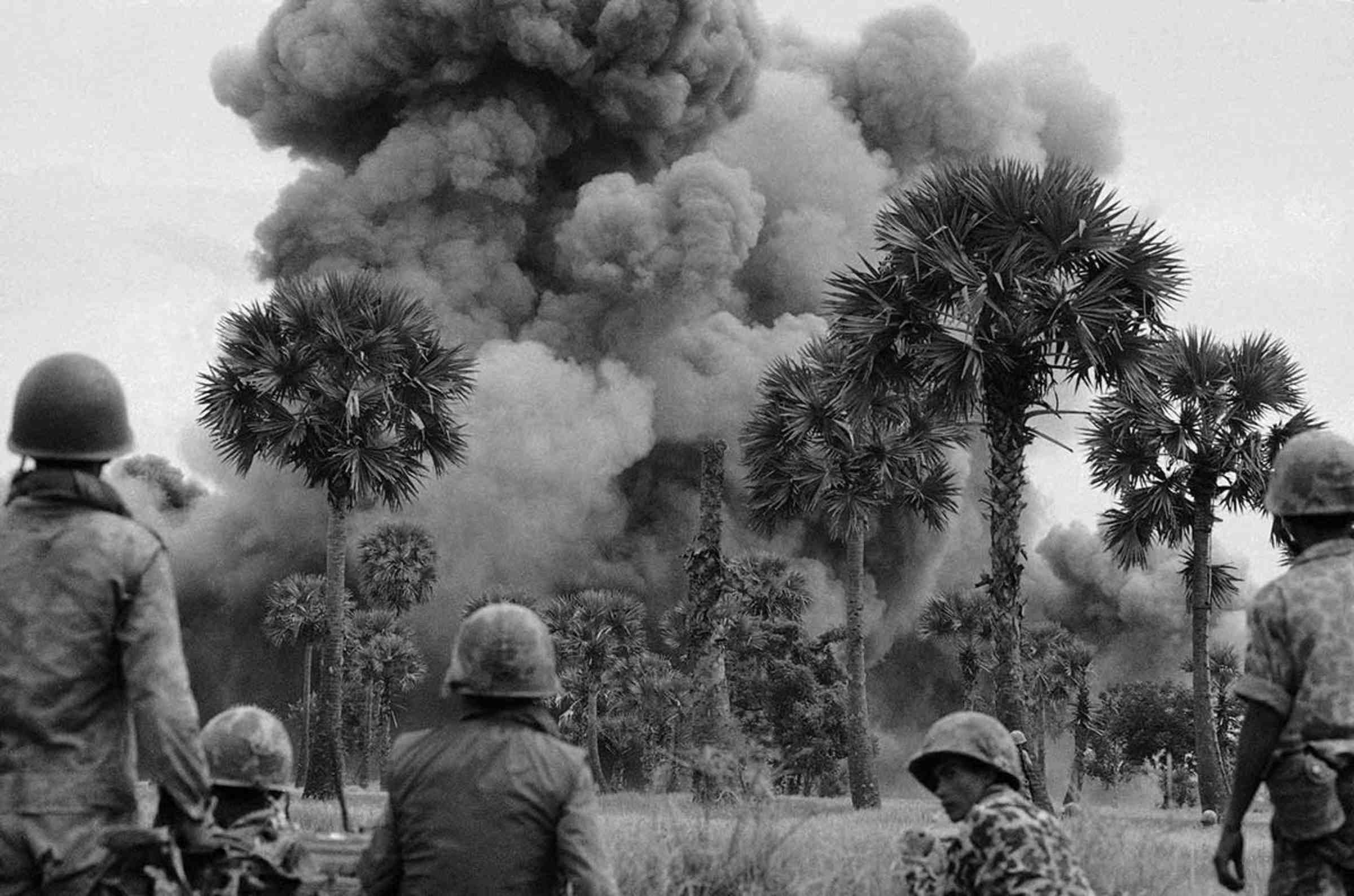 Soldiers looking at a large cloud of smoke