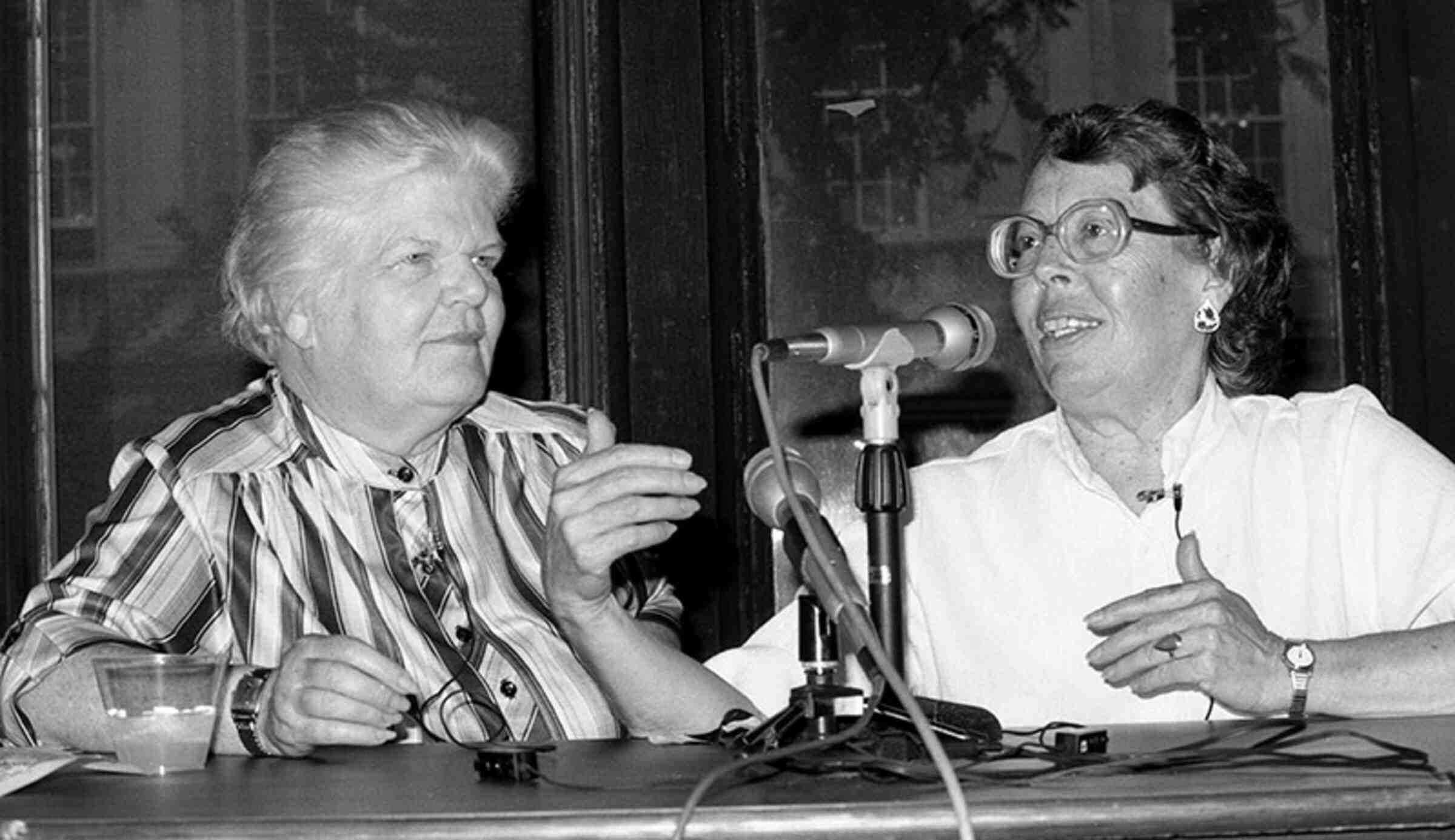 Del Martin and Phyllis Lyon speaking into microphones