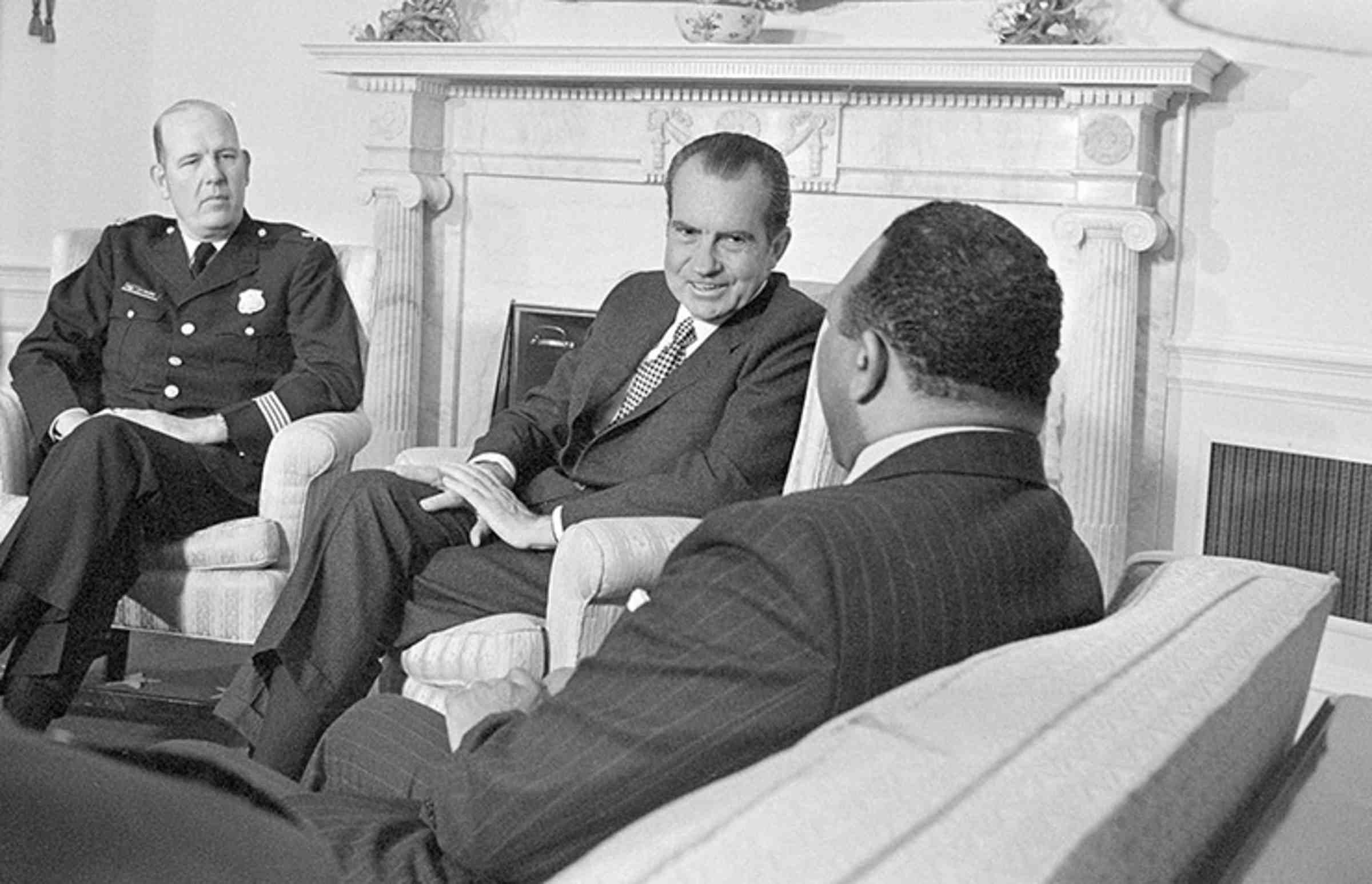 Richard M. Nixon sitting and talking with Police Chief Jerry Wilson and Mayor Walter E. Washington