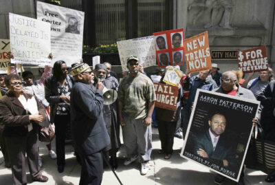 A group of demonstrators rally outside Chicago's City Hall