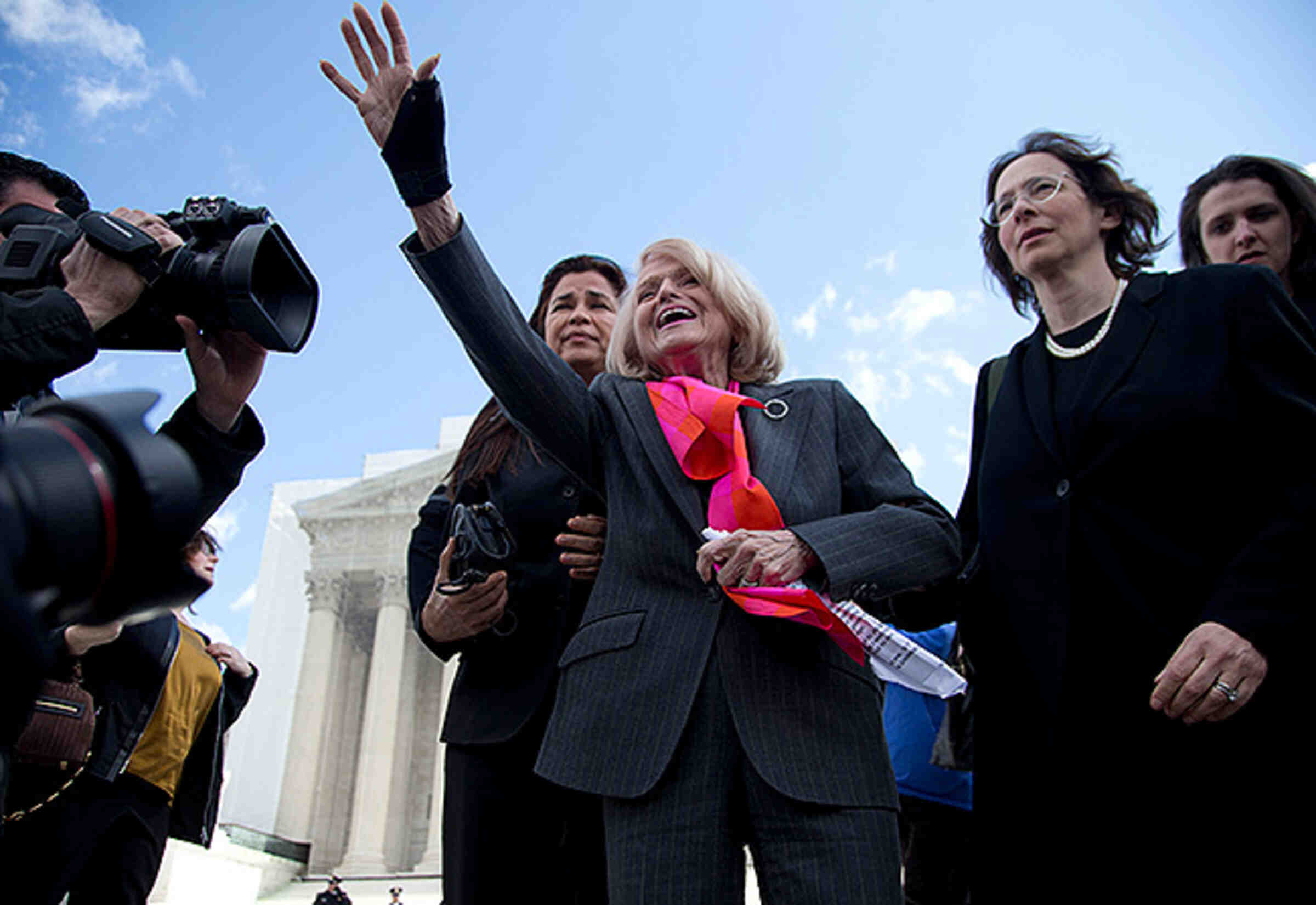 Plaintiff Edith Windsor waves to supporters in front of the Supreme Court in Washington, Wednesday, March 27, 2013, after the court heard arguments on her Defense of Marriage Act (DOMA) case. (Credit: AP Photo/Carolyn Kaster)