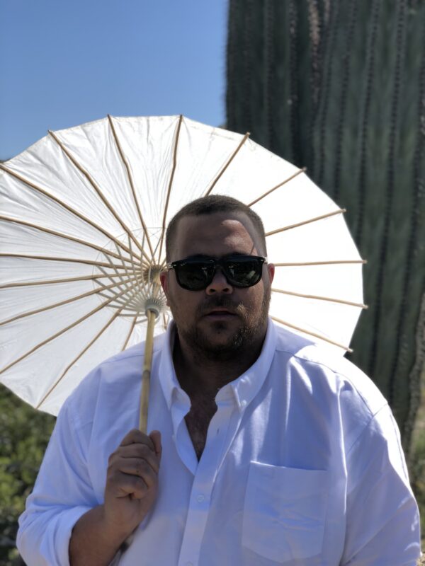 ϰſ Head of Digital Engagement Stefan Smith poses holding a parasol