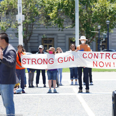 Protesters hold a banner that says "Strong gun control now" during an anti-gun violence rally in San Francisco rally.