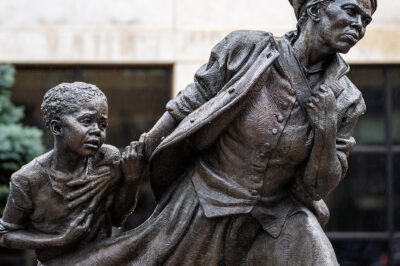 White Plains, NY - USA - April 3, 2022: Closeup of Wesley Wofford's 9 ft bronze sculpture, Harriet Tubman — The Journey to Freedom. Depicting Tubman leading a young enslaved girl to freedom.