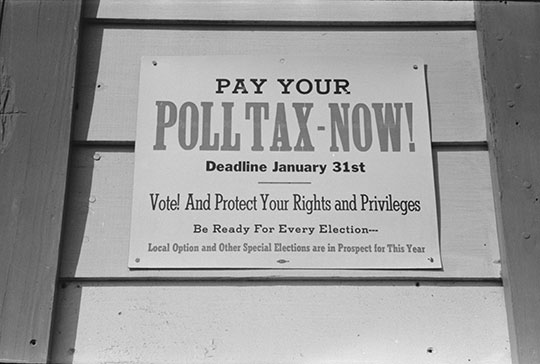 A sign with the headline: "Pay Your Poll Tax Now!"