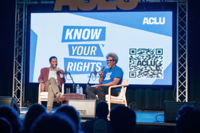 A photo of W. Kamau Bell on stage during the ϰſ Know Your Rights Bus Tour.