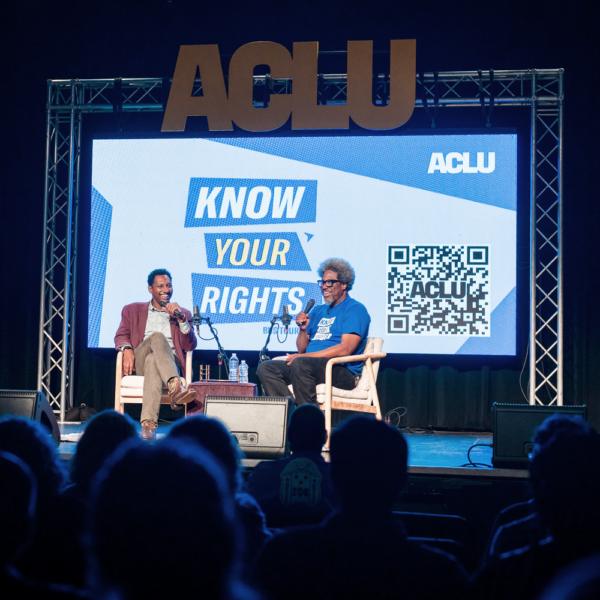 A photo of W. Kamau Bell on stage during the ACLU Know Your Rights Bus Tour.