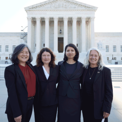 Cecillia Wang and others standing on the front steps in front of the Supreme Court