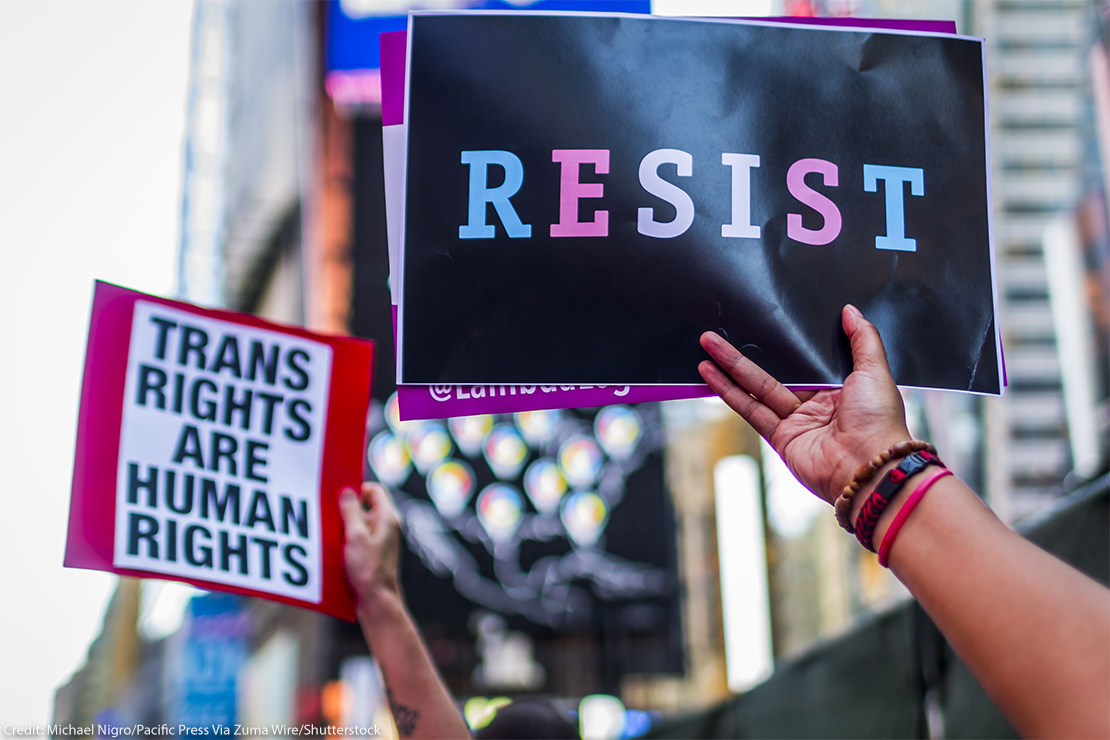 "Trans Rights are Human Rights" and "RESIST" signs