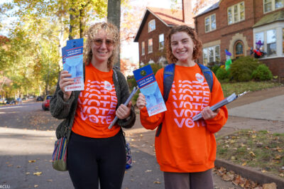 Voter volunteers holding voting pamphlets.